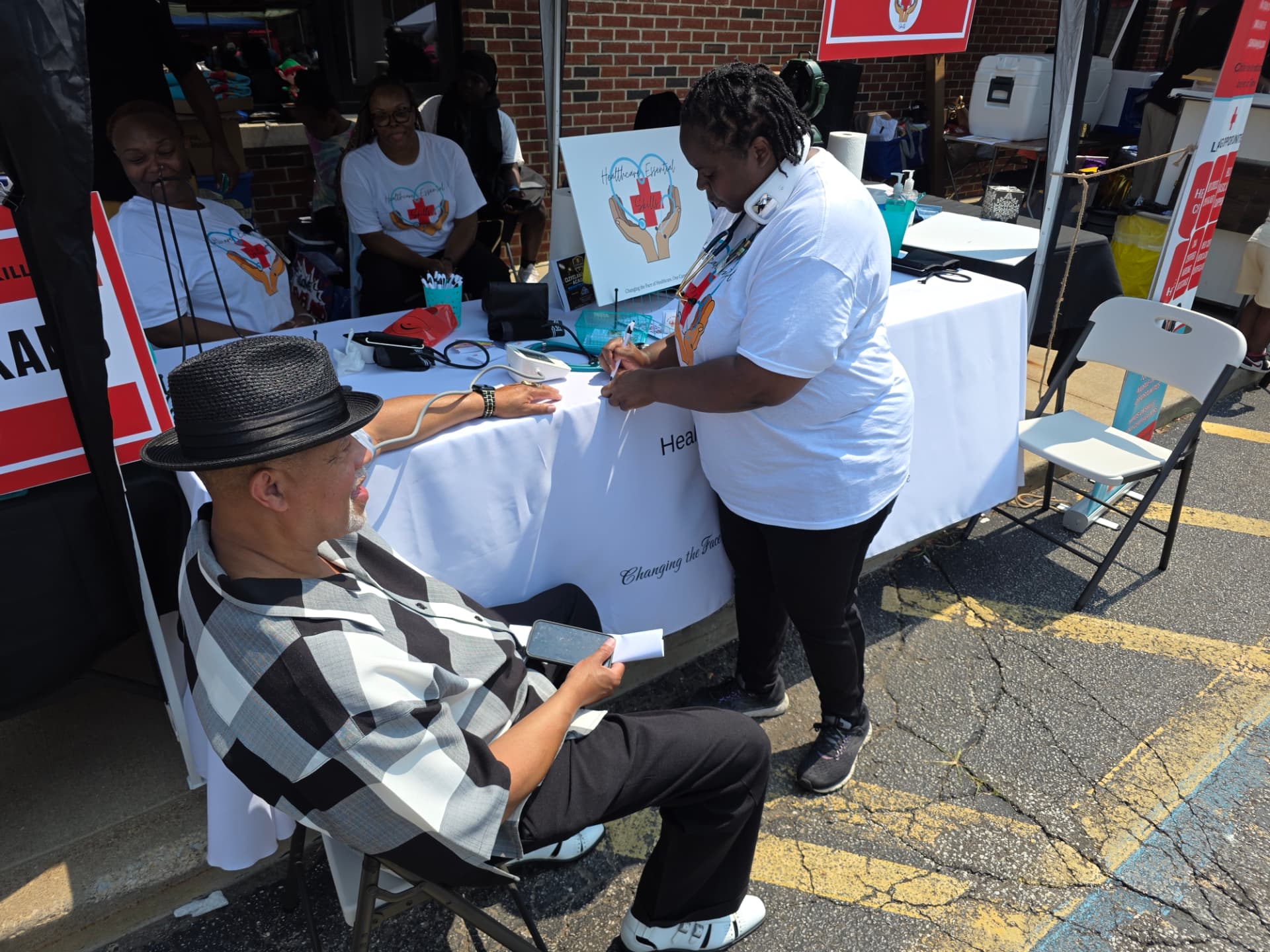 Instructor recording a blood pressure reading at the Healthcare Essential Skills booth